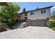 Inviting two-story home with a charming front yard, beautiful landscaping and a two-car garage at 1073 Xenon St, Golden, CO 80401