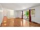 Spacious living room featuring wood floors, ample natural light from the sliding glass doors and white walls at 1073 Xenon St, Golden, CO 80401