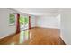Bright living room with hardwood floors and sliding glass doors with red curtains at 1073 Xenon St, Golden, CO 80401