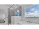 Bright bathroom featuring a soaking tub, glass-enclosed shower, and scenic views at 900 Eldorado Ln, Louisville, CO 80027