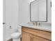 Bright bathroom featuring a modern vanity with quartz countertop, stylish faucet, and a large mirror at 900 Eldorado Ln, Louisville, CO 80027