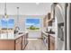 Bright kitchen with stainless steel appliances, view to the outdoor space, and hardwood floors at 900 Eldorado Ln, Louisville, CO 80027