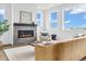 Inviting living room features a stone fireplace and large windows for ample natural light at 900 Eldorado Ln, Louisville, CO 80027