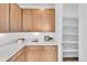 Bright and airy pantry features quartz countertops, custom cabinets, and easy access to a walk-in space at 900 Eldorado Ln, Louisville, CO 80027