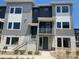 Modern townhome with gray siding, white accents, and large windows for ample natural light at 688 Belay St, Erie, CO 80516