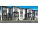 Modern townhome exterior showcasing gray and white color schemes, with balconies and well-maintained landscaping at 688 Belay St, Erie, CO 80516
