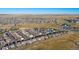 Expansive aerial view of a suburban neighborhood, showcasing community layout and surrounding landscape with blue sky at 1392 S Duquesne Cir, Aurora, CO 80018