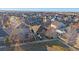 A neighborhood aerial view showcases the community with houses, landscaping, and mountain views at 1392 S Duquesne Cir, Aurora, CO 80018