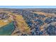 This aerial shot features homes nestled among greenery and a pond in the suburban community at 1392 S Duquesne Cir, Aurora, CO 80018