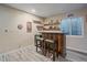 Basement wet bar with bar seating, shelving, and storage for entertaining at 1392 S Duquesne Cir, Aurora, CO 80018