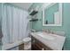 Bathroom features granite vanity, framed mirror, and tub with blue shower curtain at 1392 S Duquesne Cir, Aurora, CO 80018