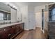 Bathroom with dual sinks, a granite countertop, and a tile-surround shower at 1392 S Duquesne Cir, Aurora, CO 80018