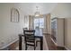 Dining room with a large window, stylish light fixture, and wood-look tile flooring at 1392 S Duquesne Cir, Aurora, CO 80018