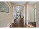 Inviting hallway with wood-look tile floors and arched doorways offering a glimpse into the living spaces at 1392 S Duquesne Cir, Aurora, CO 80018