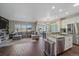 Open-concept living room and kitchen area with an island, stainless steel appliances, and sliding glass doors to the outside at 1392 S Duquesne Cir, Aurora, CO 80018