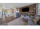 Stylish living room with a wood accent wall, fireplace, and comfortable sectional sofa at 1392 S Duquesne Cir, Aurora, CO 80018