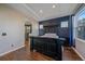 Comfortable main bedroom with dark accent wall, tray ceiling and views to ensuite bath at 1392 S Duquesne Cir, Aurora, CO 80018