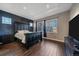 Spacious main bedroom with dark accent wall, tray ceiling and wood-look flooring at 1392 S Duquesne Cir, Aurora, CO 80018