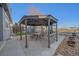 This backyard shows an outdoor patio space with a gazebo, dining set, and view of the surroundings at 1392 S Duquesne Cir, Aurora, CO 80018