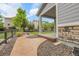 Backyard featuring stone walkway, well-kept lawn, and covered patio, ideal for outdoor relaxation at 23895 E Rocky Top Pl, Aurora, CO 80016