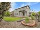 Green backyard features a stone patio and lush lawn at 23895 E Rocky Top Pl, Aurora, CO 80016
