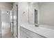 Bathroom featuring a single vanity, framed mirror, and doorway to another room at 23895 E Rocky Top Pl, Aurora, CO 80016