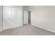 Bedroom featuring plush carpet, double closet, and a doorway to another room at 23895 E Rocky Top Pl, Aurora, CO 80016