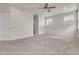 Large bedroom with fan, windows, and neutral color scheme at 23895 E Rocky Top Pl, Aurora, CO 80016
