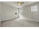 Neutral bedroom with carpet, ceiling fan, and three windows letting in natural light at 23895 E Rocky Top Pl, Aurora, CO 80016