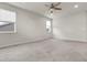 Spacious bedroom featuring neutral carpet, fan, and natural light at 23895 E Rocky Top Pl, Aurora, CO 80016