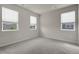 Bedroom featuring carpet floors, three windows, and neutral wall color at 23895 E Rocky Top Pl, Aurora, CO 80016