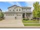 Beautiful two-story home featuring an attached three-car garage and inviting front porch at 23895 E Rocky Top Pl, Aurora, CO 80016