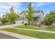 A wide view of the house with an attached three-car garage with a well-manicured lawn at 23895 E Rocky Top Pl, Aurora, CO 80016