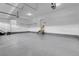 Spacious garage with epoxy flooring, ample lighting, and access to interior at 23895 E Rocky Top Pl, Aurora, CO 80016