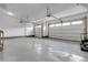 Spacious garage with epoxy flooring, two car doors, and ample lighting at 23895 E Rocky Top Pl, Aurora, CO 80016