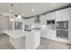 Modern kitchen featuring stainless steel appliances, white cabinetry and a large center island at 23895 E Rocky Top Pl, Aurora, CO 80016