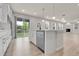 Stylish kitchen with island, stainless steel dishwasher, and sliding door access to the backyard at 23895 E Rocky Top Pl, Aurora, CO 80016
