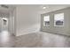 Living room with hardwood floors and large windows providing ample natural light at 23895 E Rocky Top Pl, Aurora, CO 80016