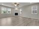 Cozy living room featuring fireplace, recessed lighting, and multiple windows at 23895 E Rocky Top Pl, Aurora, CO 80016