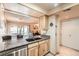 Kitchen with granite countertops, stainless steel dishwasher, and a view into the living room at 14130 E Temple Dr # T01, Aurora, CO 80015
