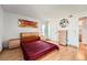 Comfortable primary bedroom with a spacious layout, hardwood flooring, and stylish decor at 14130 E Temple Dr # T01, Aurora, CO 80015