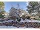 Two-story home with stone wall and snowy landscaping at 9877 Grove St # C, Westminster, CO 80031