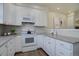 Well-equipped kitchen featuring white cabinets and granite countertops at 9877 Grove St # C, Westminster, CO 80031