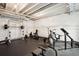 Basement gym with rubber floors and weight equipment, including a squat rack, benches, and weight machines at 23814 E 36Th Pl, Aurora, CO 80019