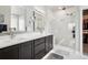 Elegant bathroom with a double vanity, large mirrors, glass-enclosed shower and access to walk-in closet at 23814 E 36Th Pl, Aurora, CO 80019