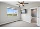 Bedroom with ample natural light, a ceiling fan, and views of the surrounding landscape through a large window at 23814 E 36Th Pl, Aurora, CO 80019
