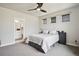 Bedroom featuring neutral tones, a ceiling fan, ample natural light, and an ensuite bathroom at 23814 E 36Th Pl, Aurora, CO 80019