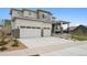 Modern two-story home with a two-car garage, stone accents, covered porch, and neat front yard landscaping at 23814 E 36Th Pl, Aurora, CO 80019