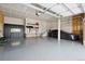 Garage with a gray floor and a Tesla vehicle; plenty of room for 2 cars and storage at 23814 E 36Th Pl, Aurora, CO 80019