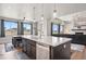 Bright, modern kitchen featuring a large island with seating, view of living room at 23814 E 36Th Pl, Aurora, CO 80019